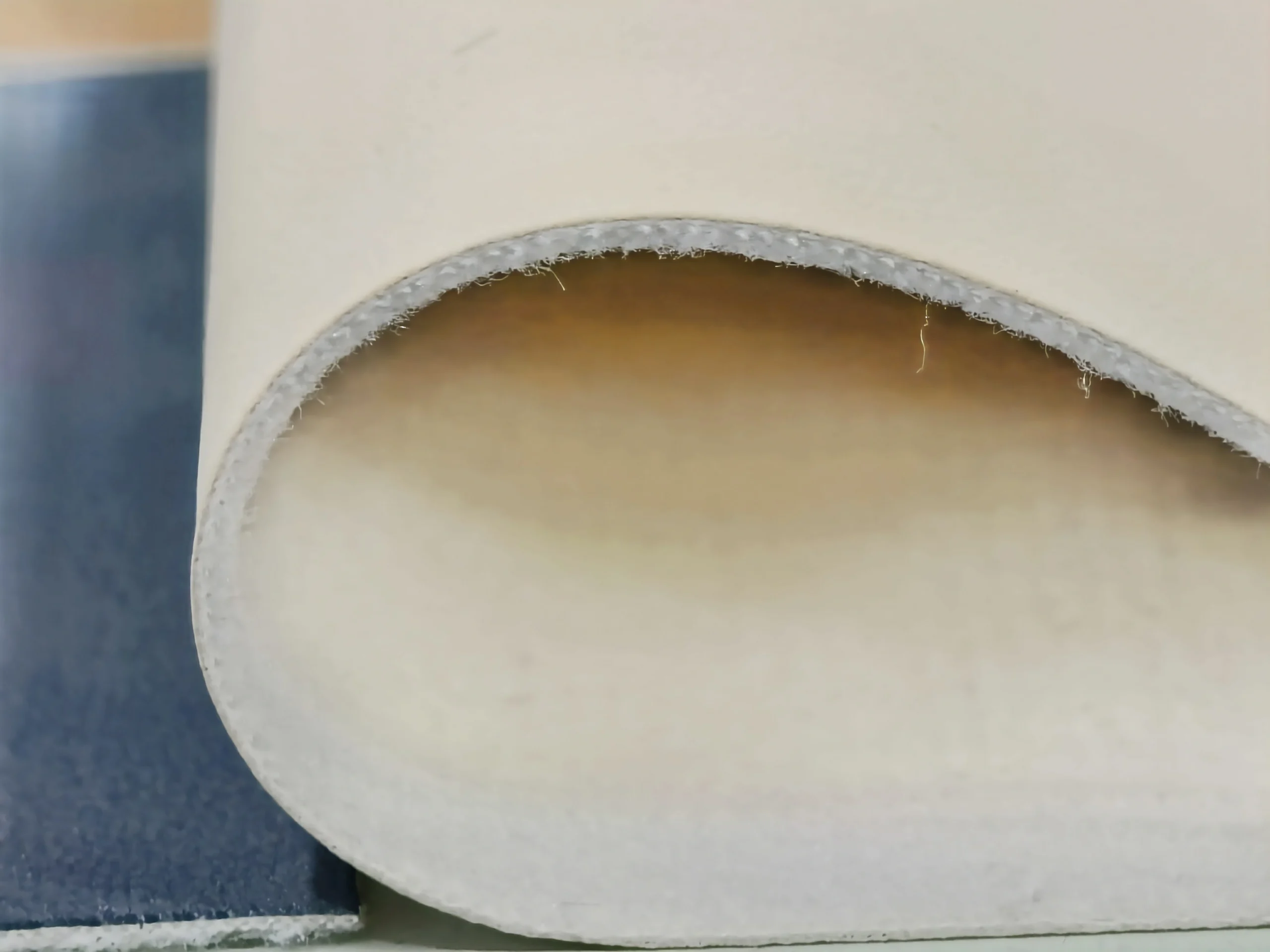 Danhon 0.9mm light beige fine grain PU leather thickness detail showing flexible material profile