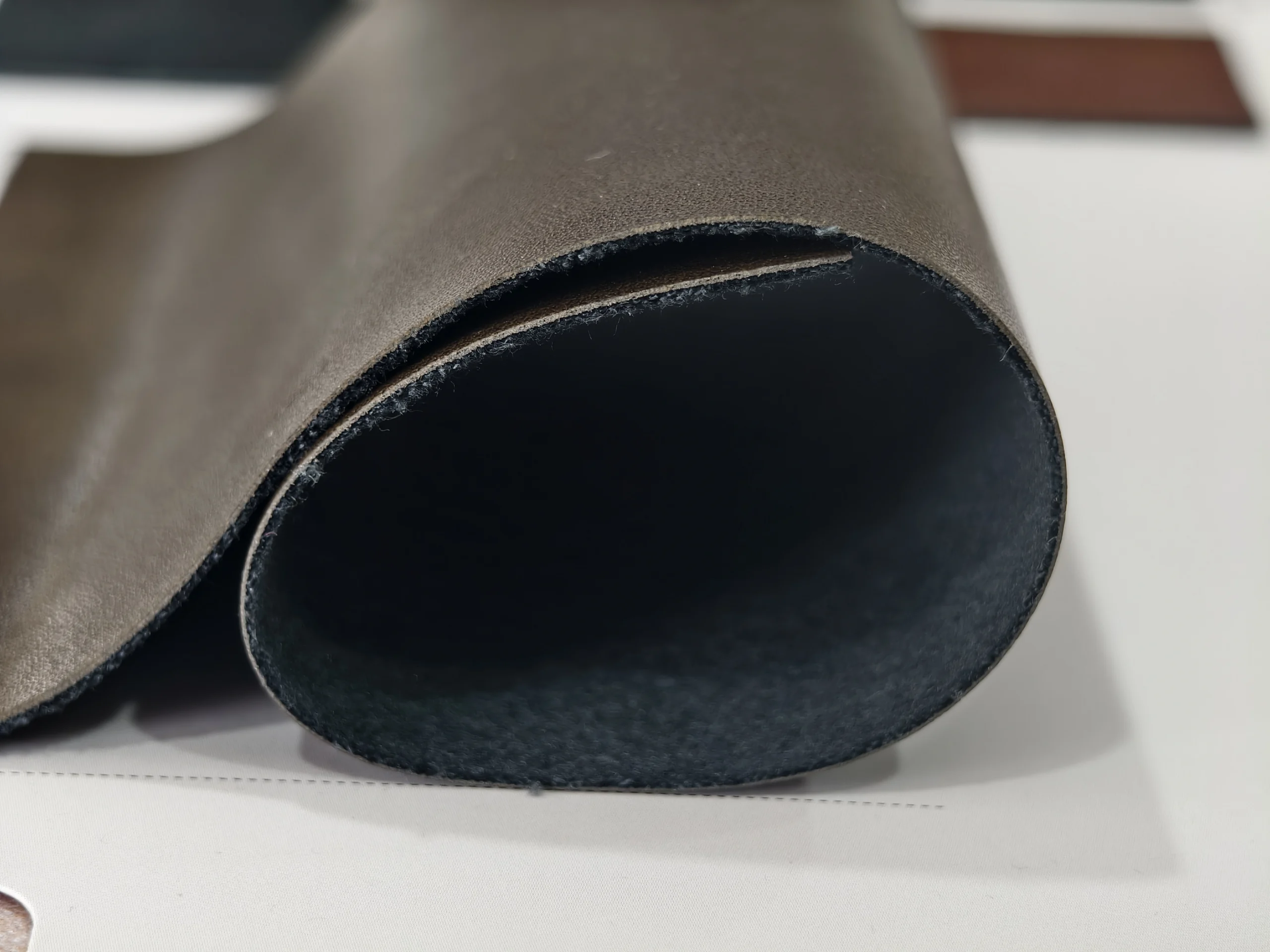 Danhon 0.8mm espresso brown matte fine pebble PU leather thickness detail showing flexible PU synthetic leather profile