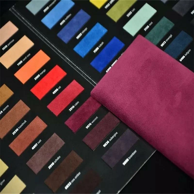 Buyer comparing small PU leather color card swatches with larger physical material samples