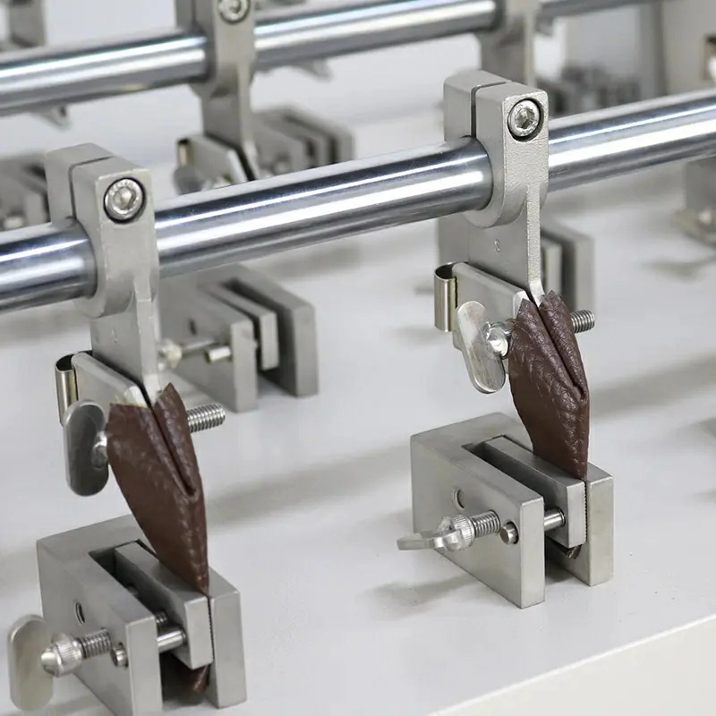 PU leather shoe upper specimens mounted in a Bally flexometer for repeated flex testing