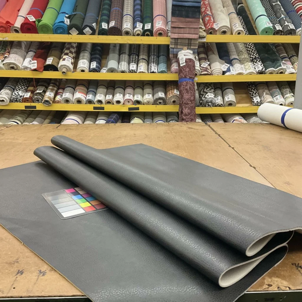 PU faux leather shown as a measured cut length beside full material rolls for B2B purchasing comparison