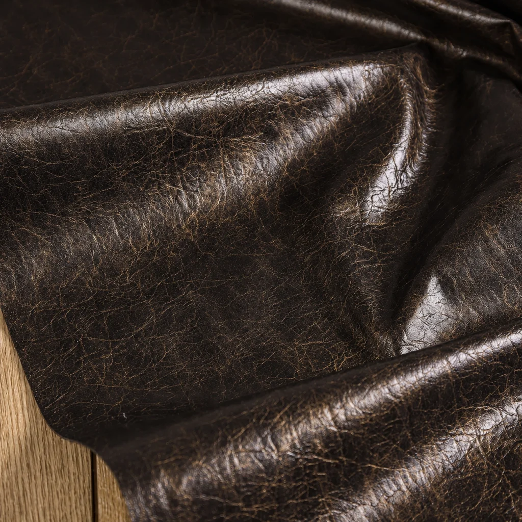 PU faux leather fabric swatch showing leather-like surface, cut edge and textile backing