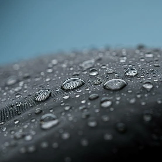 Close-up PU synthetic leather swatches with water droplets during an initial water-resistance review