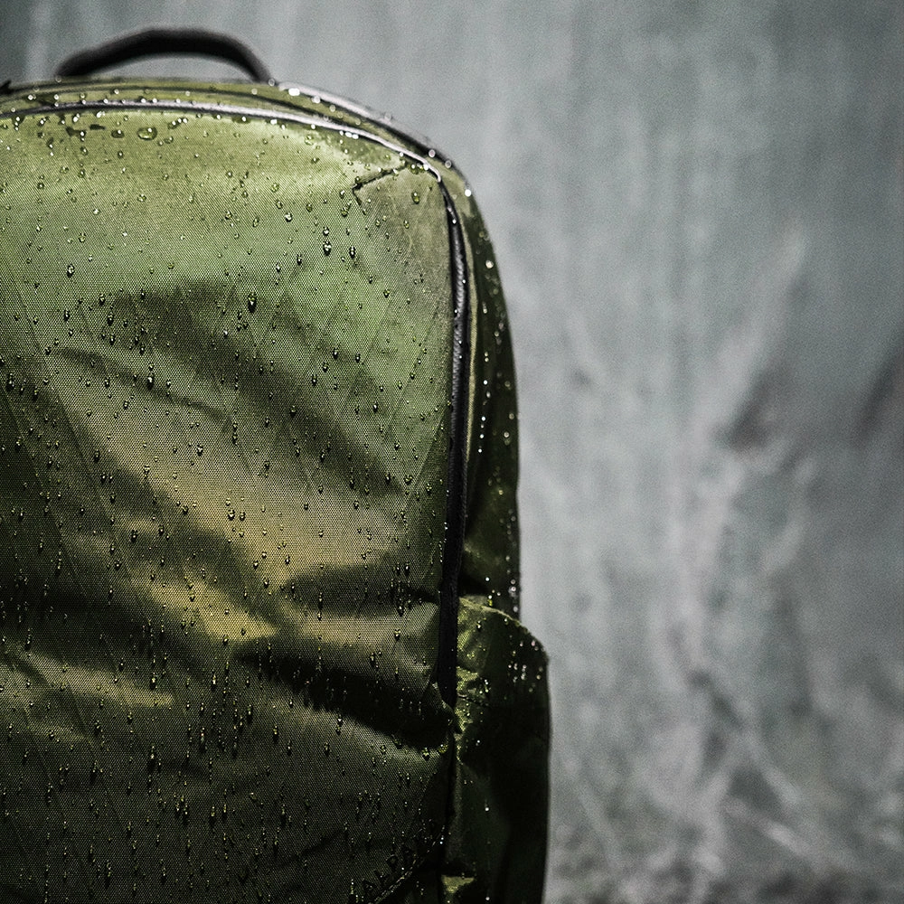 PU synthetic leather bag panel with seams zipper and stitched areas highlighted as possible water-entry points