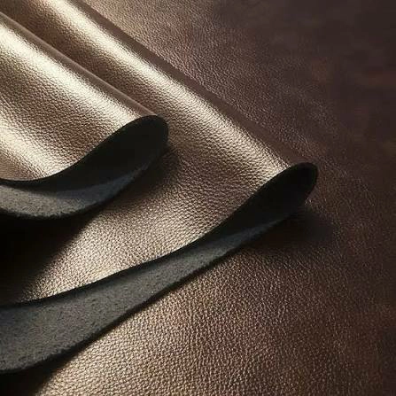 Close-up PU leather swatches showing smooth, fine pebbled and embossed surface textures under soft light