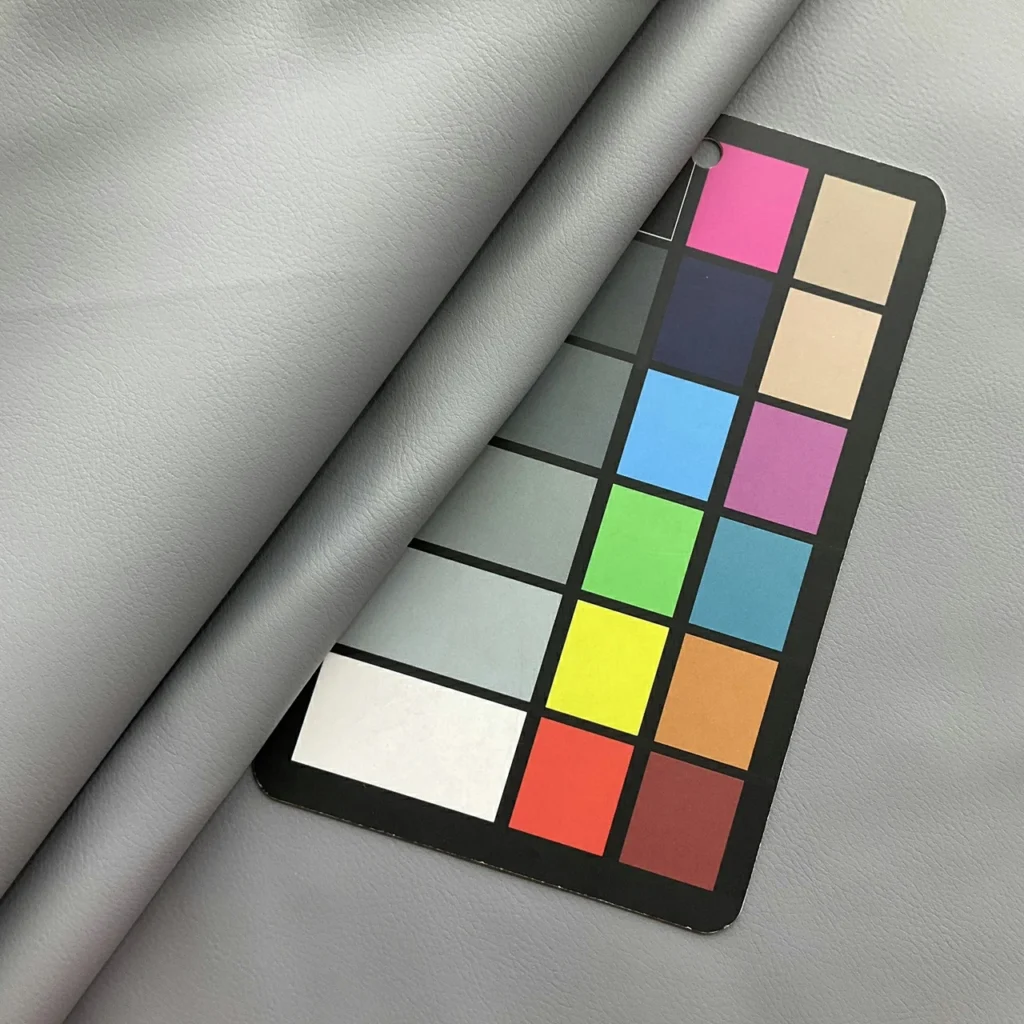 Physical PU leather swatches compared with a larger roll during sample-to-bulk material approval