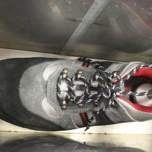 Synthetic leather shoe upper specimen being flexed during a water-resistance evaluation