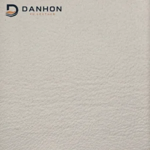 Close-up of ivory fine grain microfiber leather front surface with visible sample label