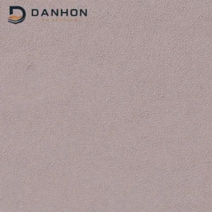 Close-up of dusty rose TPU leather material with dense irregular fine crepe-like surface texture