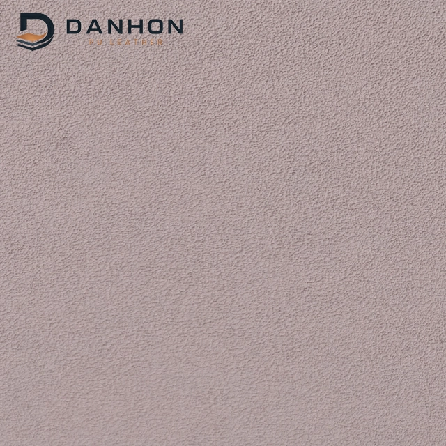 Close-up of dusty rose TPU leather material with dense irregular fine crepe-like surface texture