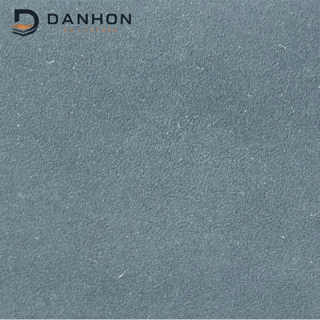 Close-up of blue-grey TPU leather material with a fine directional nubuck-like surface texture