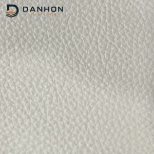 Close-up of ivory microfiber leather front surface with small pebble grain texture