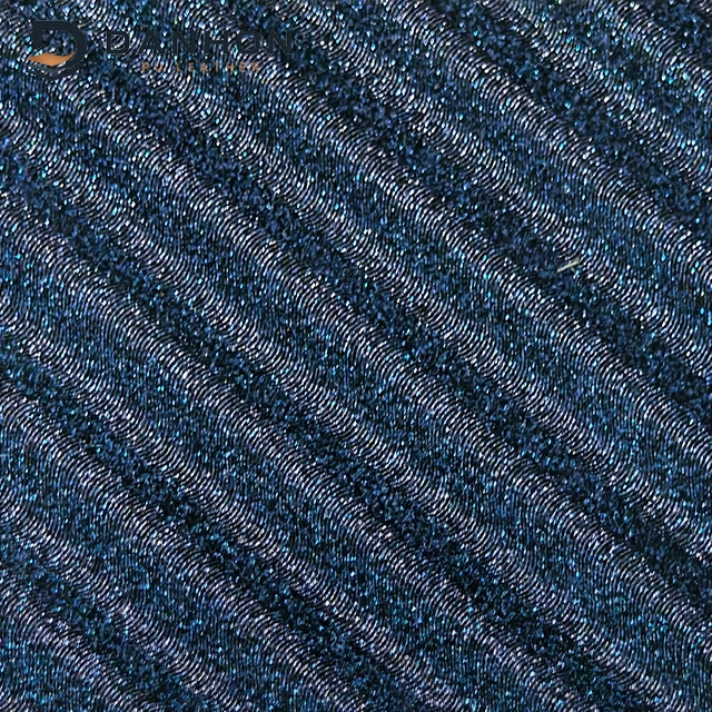 Close-up of dark navy TPU leather material with repeating swirl wave embossed lines and shimmering blue highlights